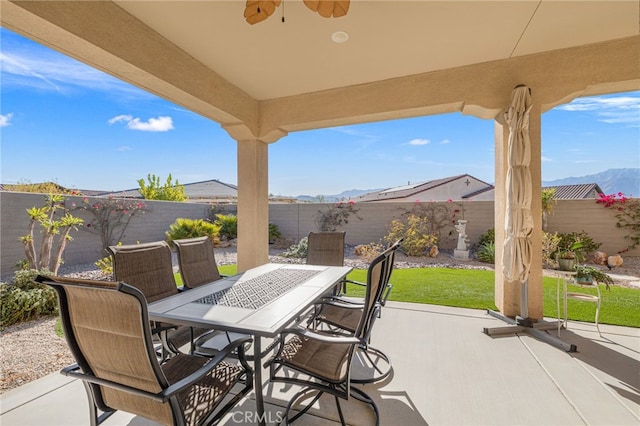 view of patio / terrace with a mountain view and ceiling fan