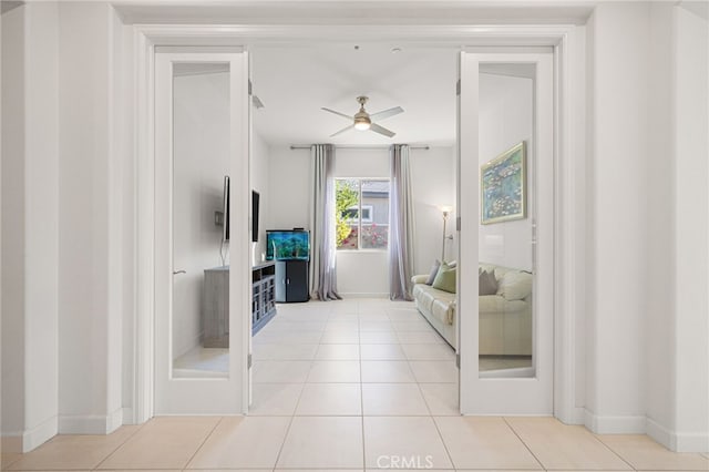 tiled living room with ceiling fan