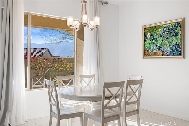 tiled dining room featuring a notable chandelier