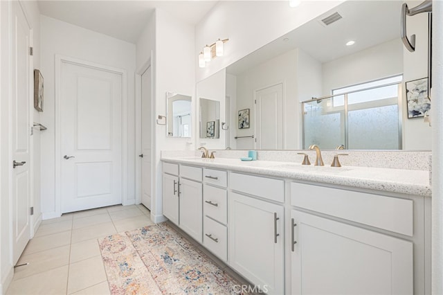 bathroom featuring vanity, tile patterned flooring, and an enclosed shower