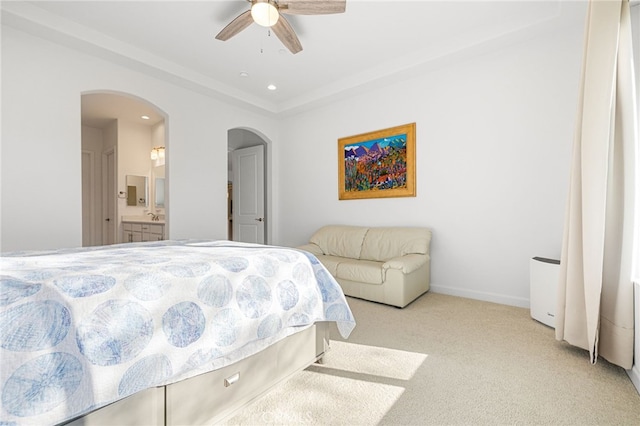 carpeted bedroom featuring ceiling fan and ensuite bath