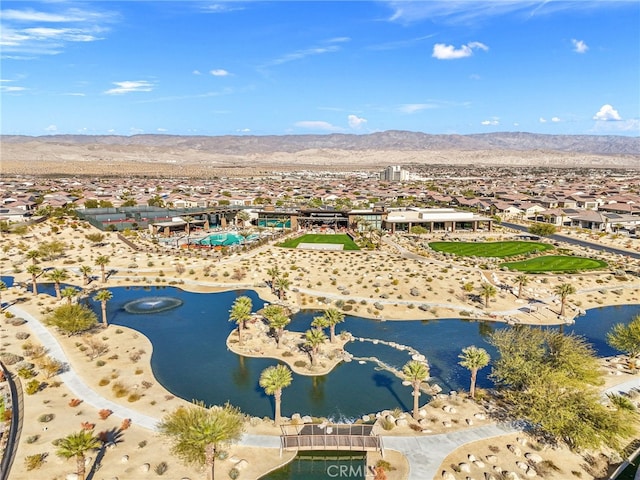 drone / aerial view with a water and mountain view