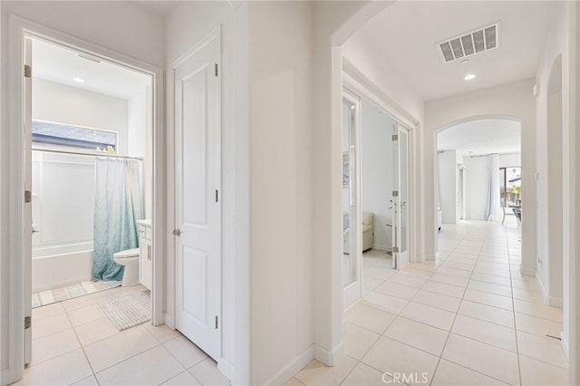 corridor featuring light tile patterned floors