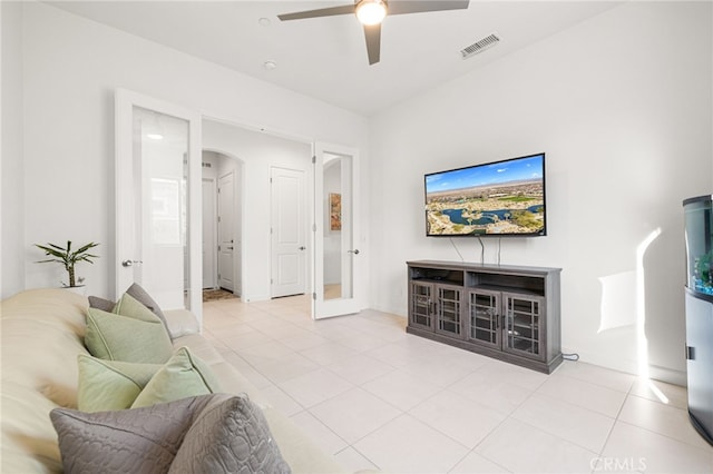 living room featuring light tile patterned flooring, french doors, and ceiling fan