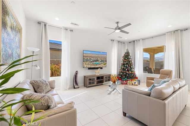 living room featuring light tile patterned floors and ceiling fan