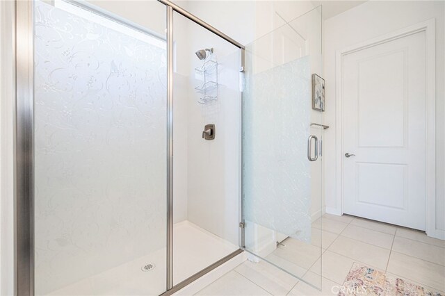 bathroom featuring tile patterned flooring and a shower with shower door