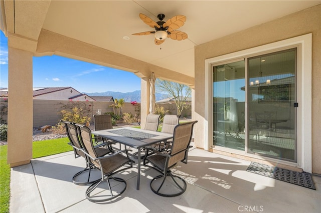 view of patio / terrace with ceiling fan and a mountain view