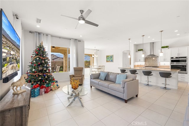 living room featuring light tile patterned flooring and ceiling fan