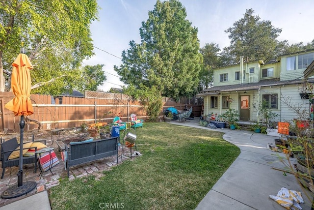 view of yard with a fenced backyard, a patio, and an outdoor hangout area