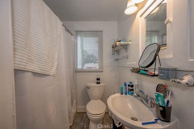 bathroom featuring toilet and a sink