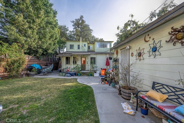 exterior space featuring a front yard, a patio area, and fence