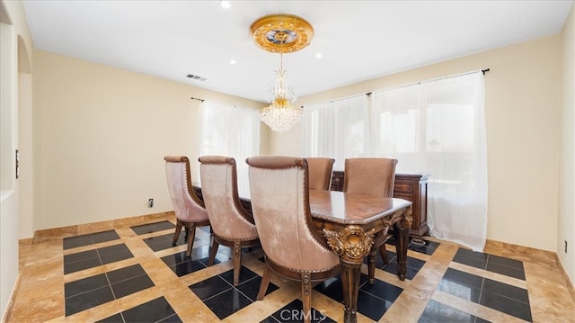 dining area featuring light tile patterned floors and a chandelier