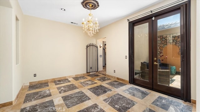 empty room with french doors and a chandelier