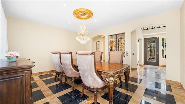 dining space with a chandelier and light tile patterned flooring