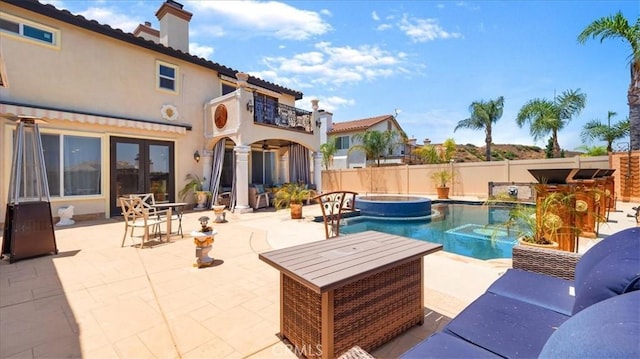 exterior space featuring an in ground hot tub and a patio