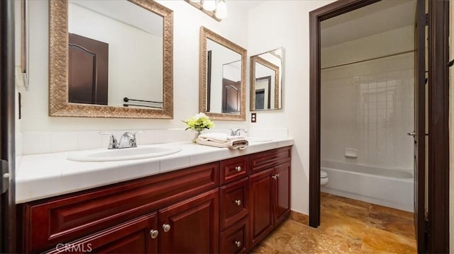 full bathroom with toilet, vanity, and tiled shower / bath combo