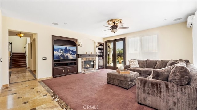 living room featuring ceiling fan, french doors, and a wall mounted air conditioner