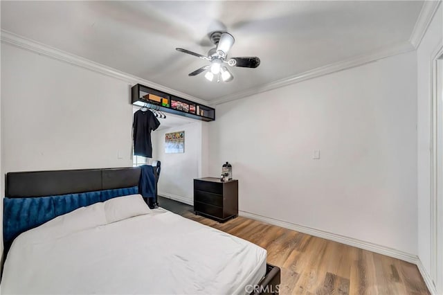 bedroom featuring ceiling fan, hardwood / wood-style floors, and ornamental molding