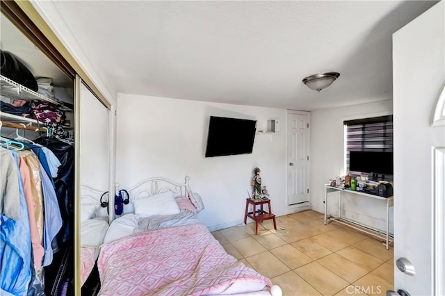 tiled bedroom featuring a closet