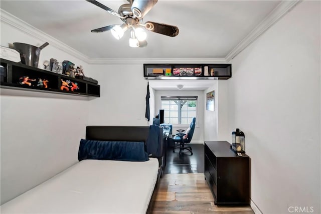 bedroom featuring ceiling fan, wood-type flooring, and ornamental molding