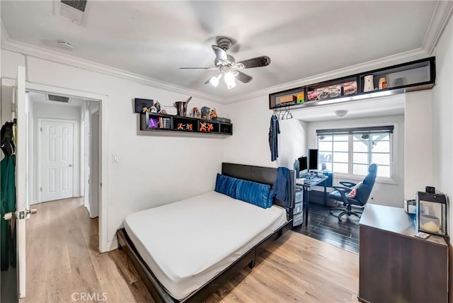 bedroom with ceiling fan, ornamental molding, and hardwood / wood-style floors