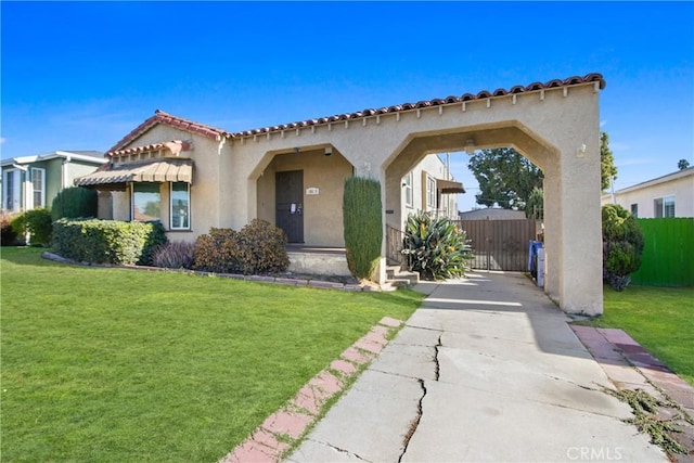 mediterranean / spanish house featuring a front yard