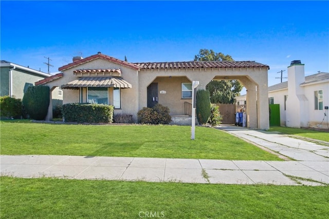 mediterranean / spanish-style house with a front yard and a carport