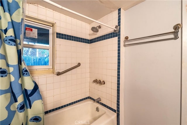 bathroom featuring shower / tub combo with curtain