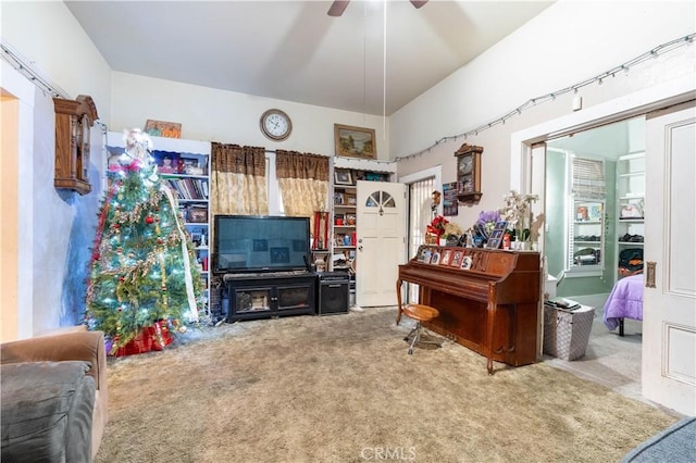 carpeted living room with ceiling fan