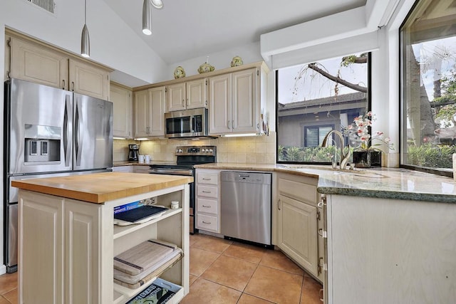 kitchen with sink, a wealth of natural light, stainless steel appliances, and wooden counters