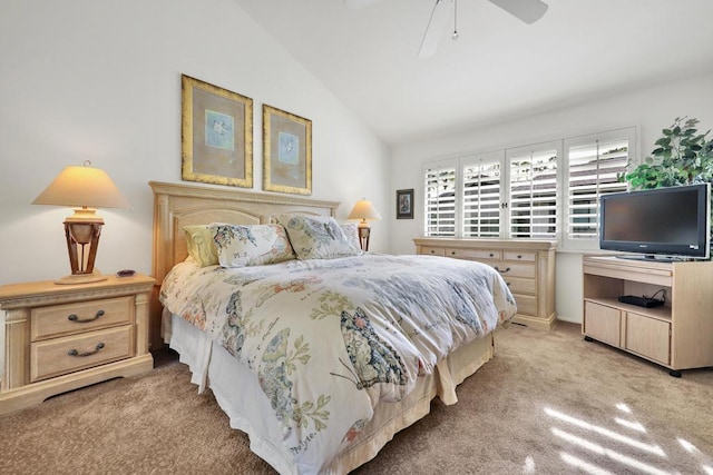 bedroom featuring vaulted ceiling, light colored carpet, and ceiling fan