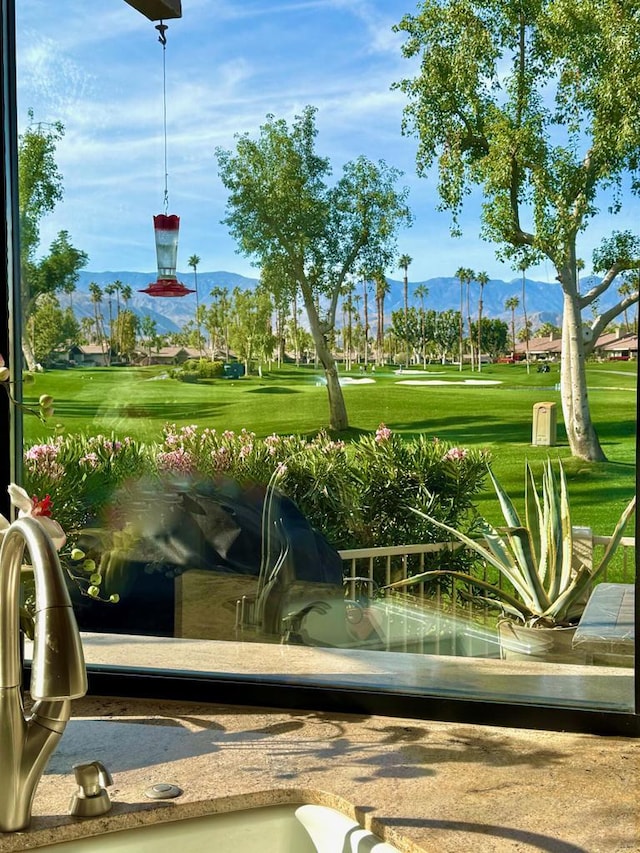 view of home's community featuring a mountain view and a lawn