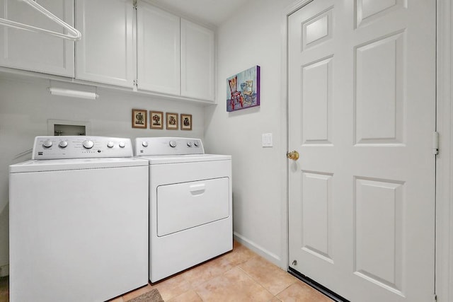 laundry area with cabinets, washing machine and clothes dryer, and light tile patterned flooring