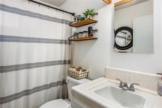 bathroom with toilet and vanity