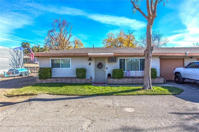 ranch-style house with a garage and a front yard