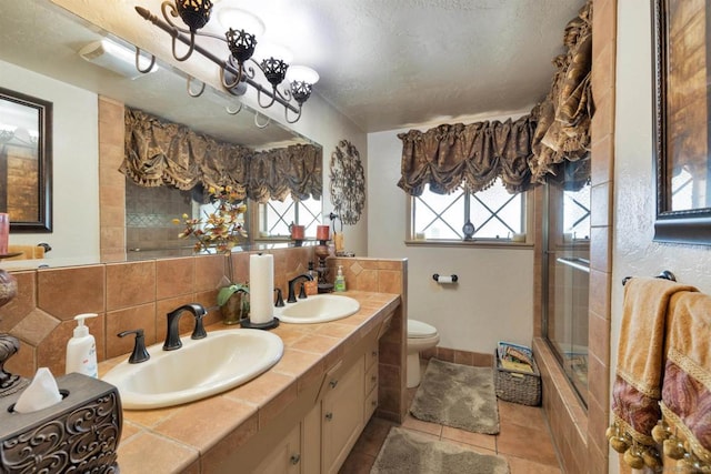 bathroom featuring toilet, tasteful backsplash, tile patterned floors, a textured ceiling, and vanity