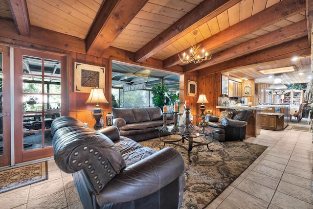 tiled living room with beam ceiling, plenty of natural light, and wooden walls