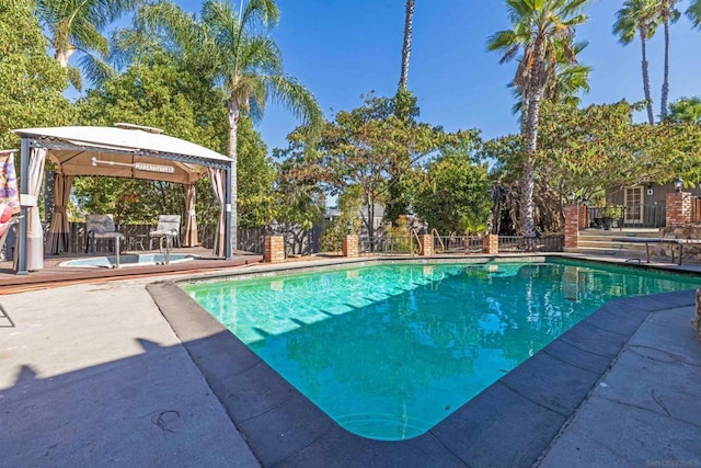 view of pool featuring a gazebo and a wooden deck