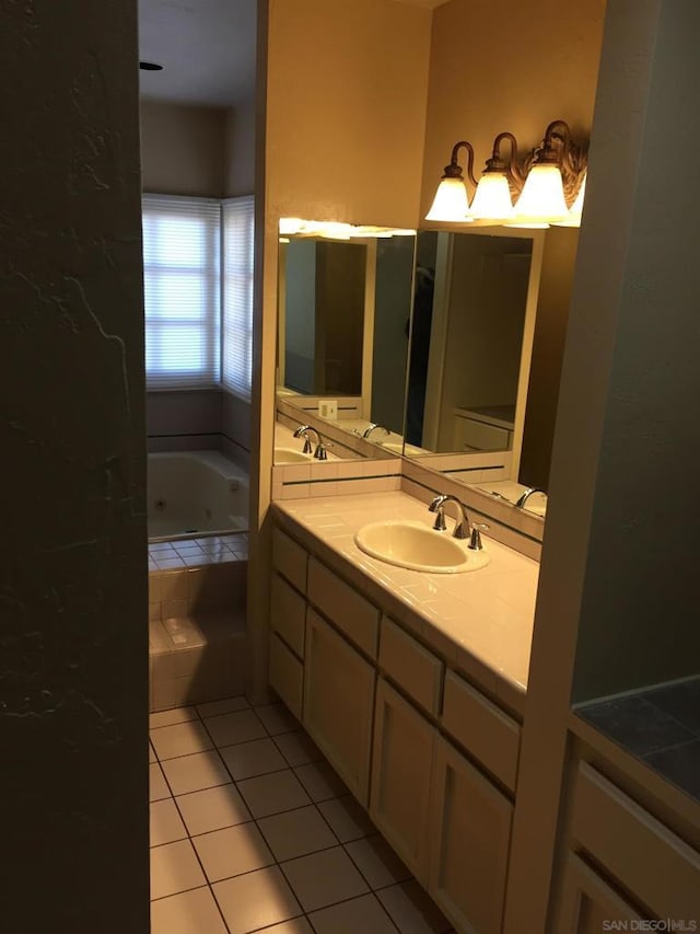 bathroom featuring tiled bath, tile patterned flooring, and vanity