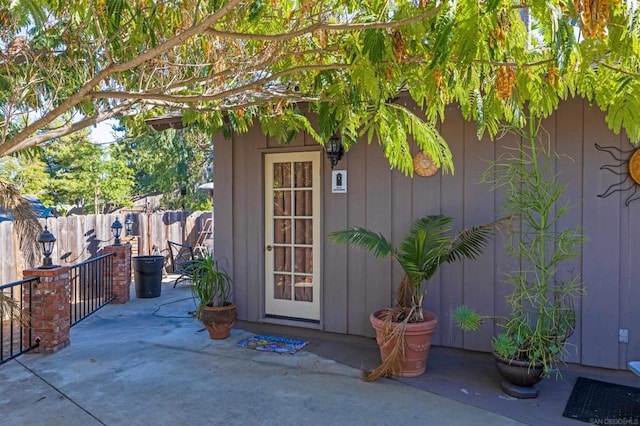 view of exterior entry featuring a patio area