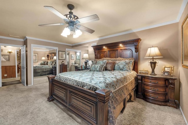 carpeted bedroom featuring ceiling fan and crown molding