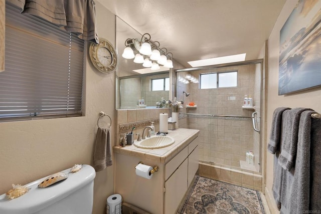 bathroom with tile patterned floors, toilet, a shower with door, and vanity