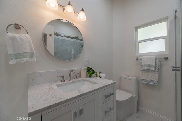 bathroom with vanity, a shower, and toilet