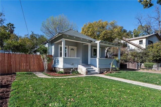 bungalow featuring a front yard and covered porch