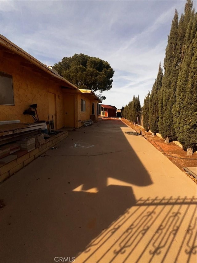 exterior space with concrete driveway and stucco siding