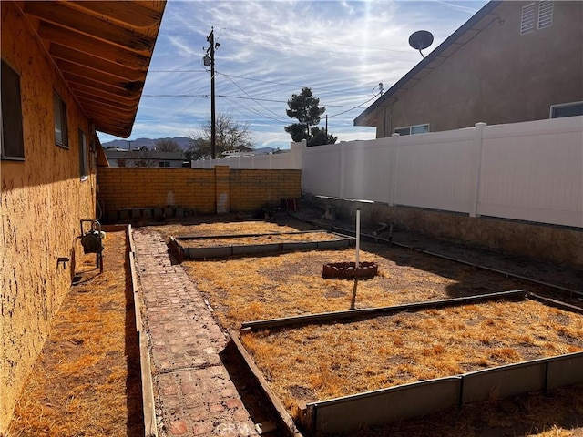 view of yard with a garden and a fenced backyard