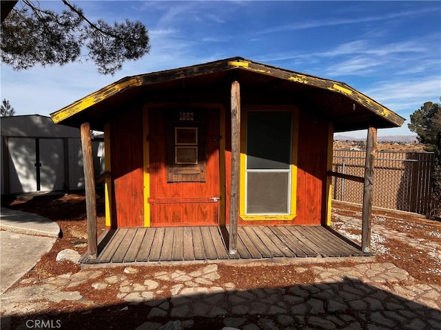 view of shed featuring fence