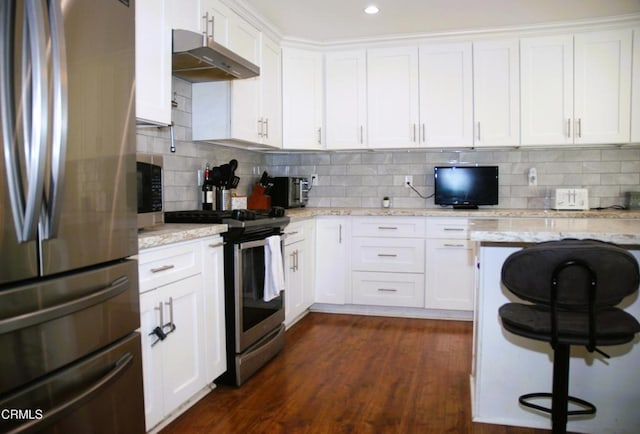 kitchen with white cabinetry, tasteful backsplash, appliances with stainless steel finishes, and light stone counters