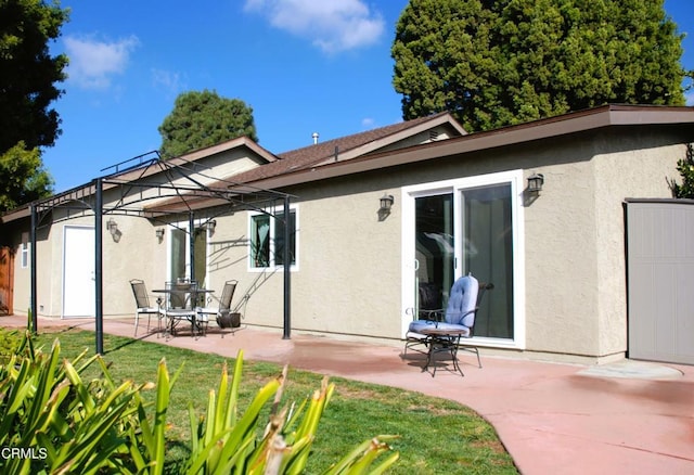 back of property with a patio and a lawn