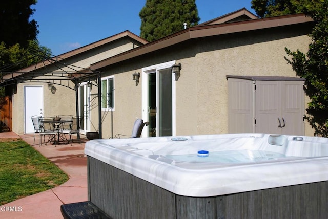 exterior space featuring a hot tub and a patio area